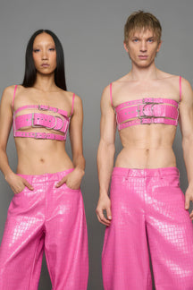 two models wearing pink vegan leather croc belt top with buckle details