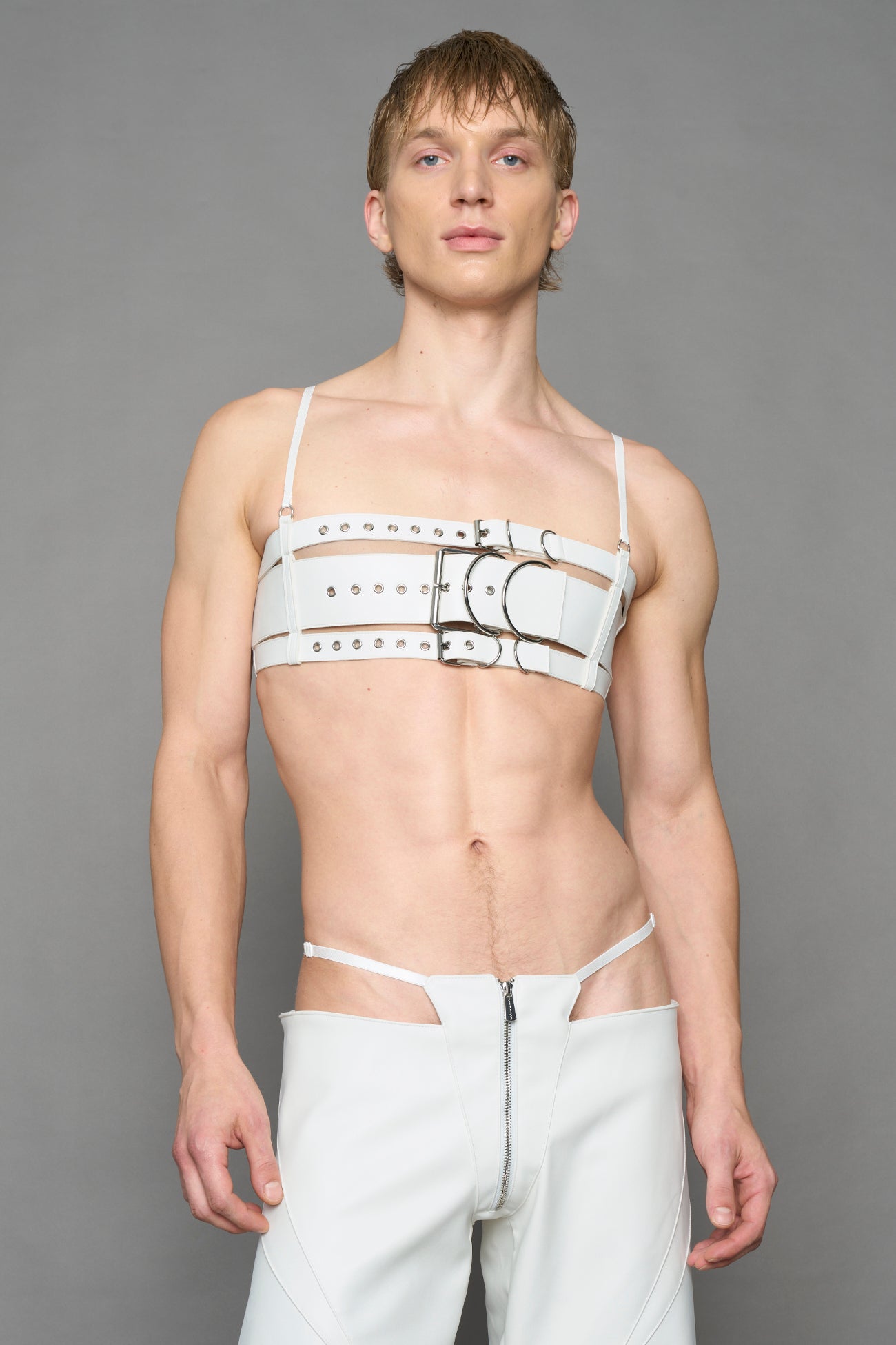 model wearing white vegan leather belt top with buckle details