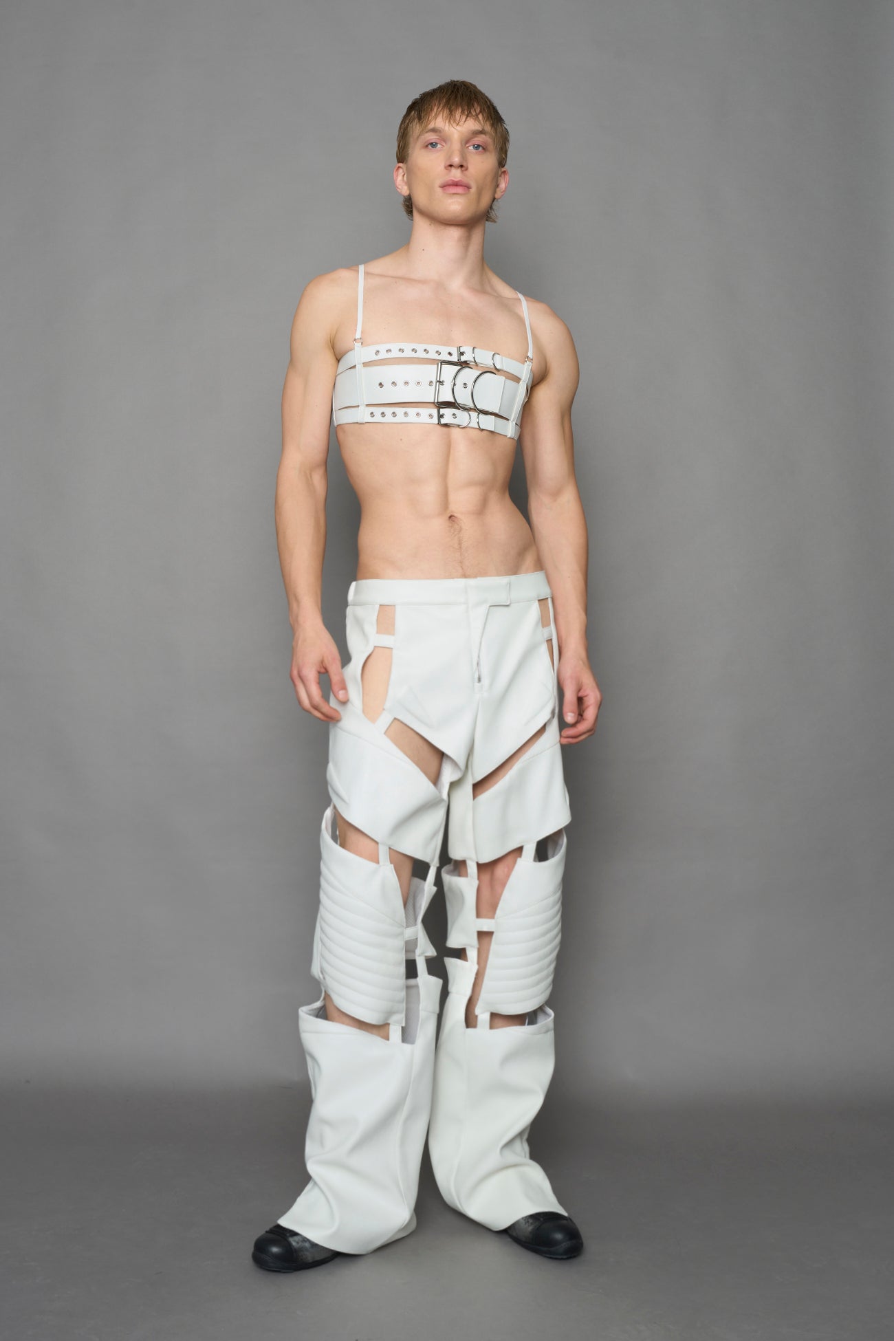 model wearing white vegan leather pants with cut out details