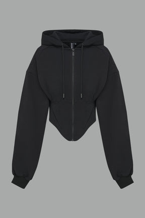 model in a black cropped hoodie featuring structured corset-style paneling  embroidered across the chest in tonal black