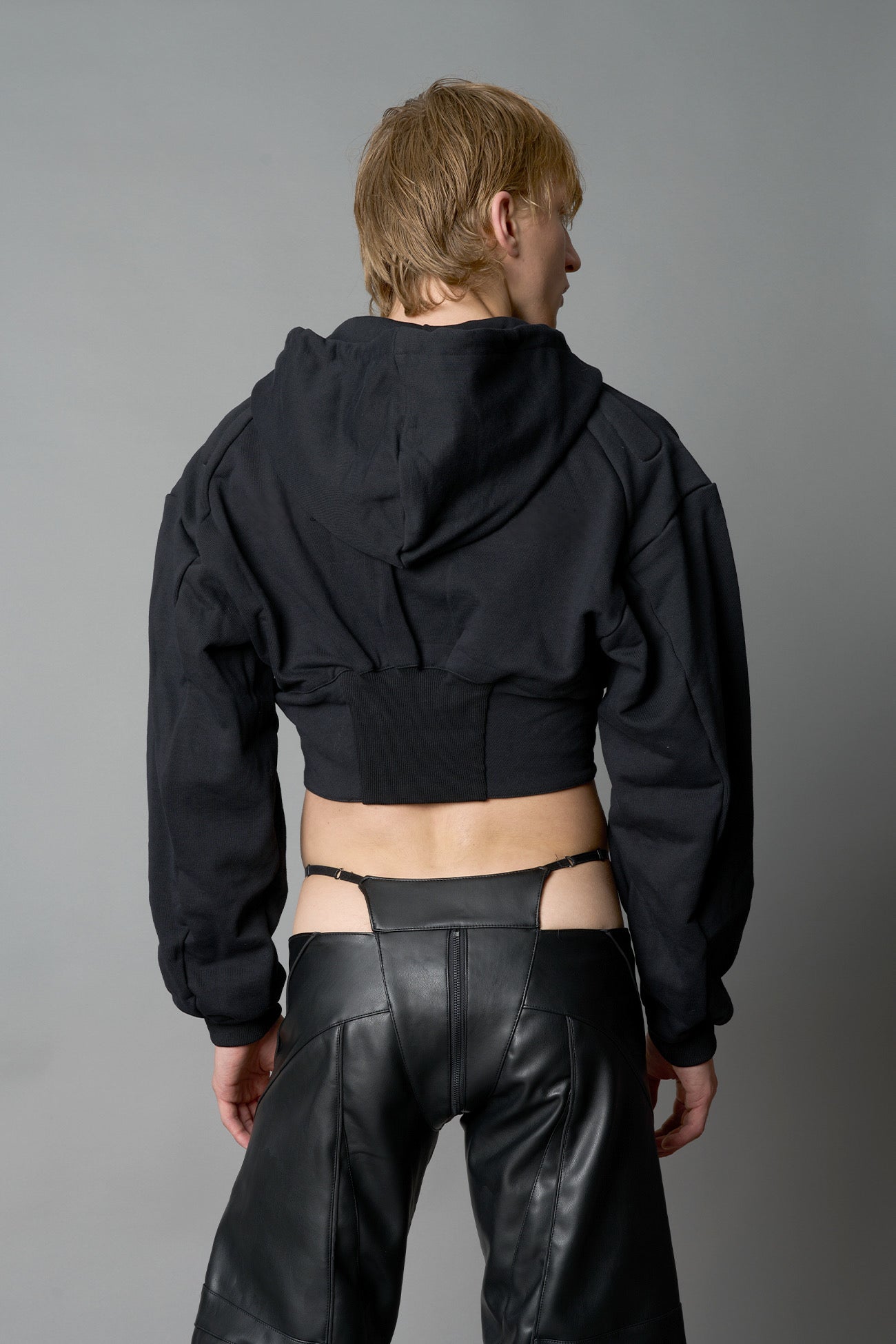 model wears black oversize hoodie with integrated corset