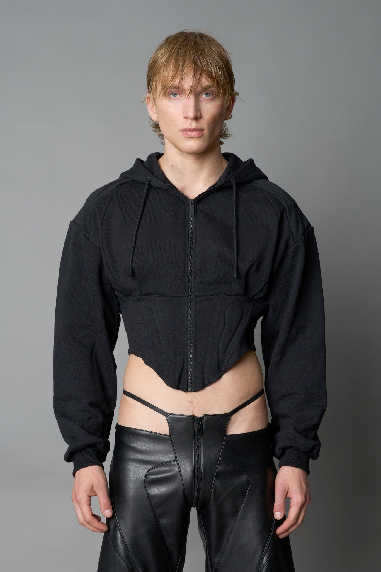 model wears black oversize hoodie with integrated corset