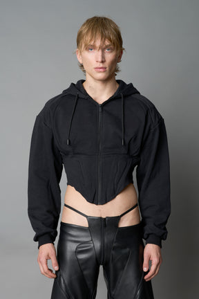 model wears black oversize hoodie with integrated corset
