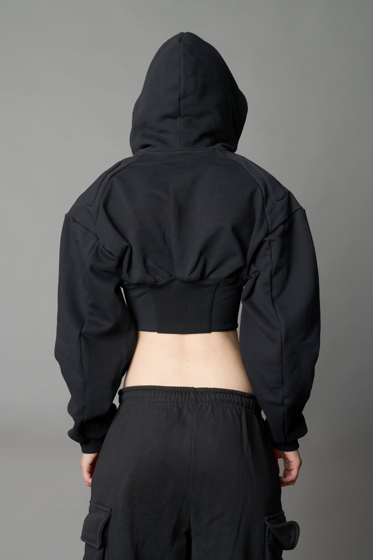 model wears black oversize hoodie with integrated corset