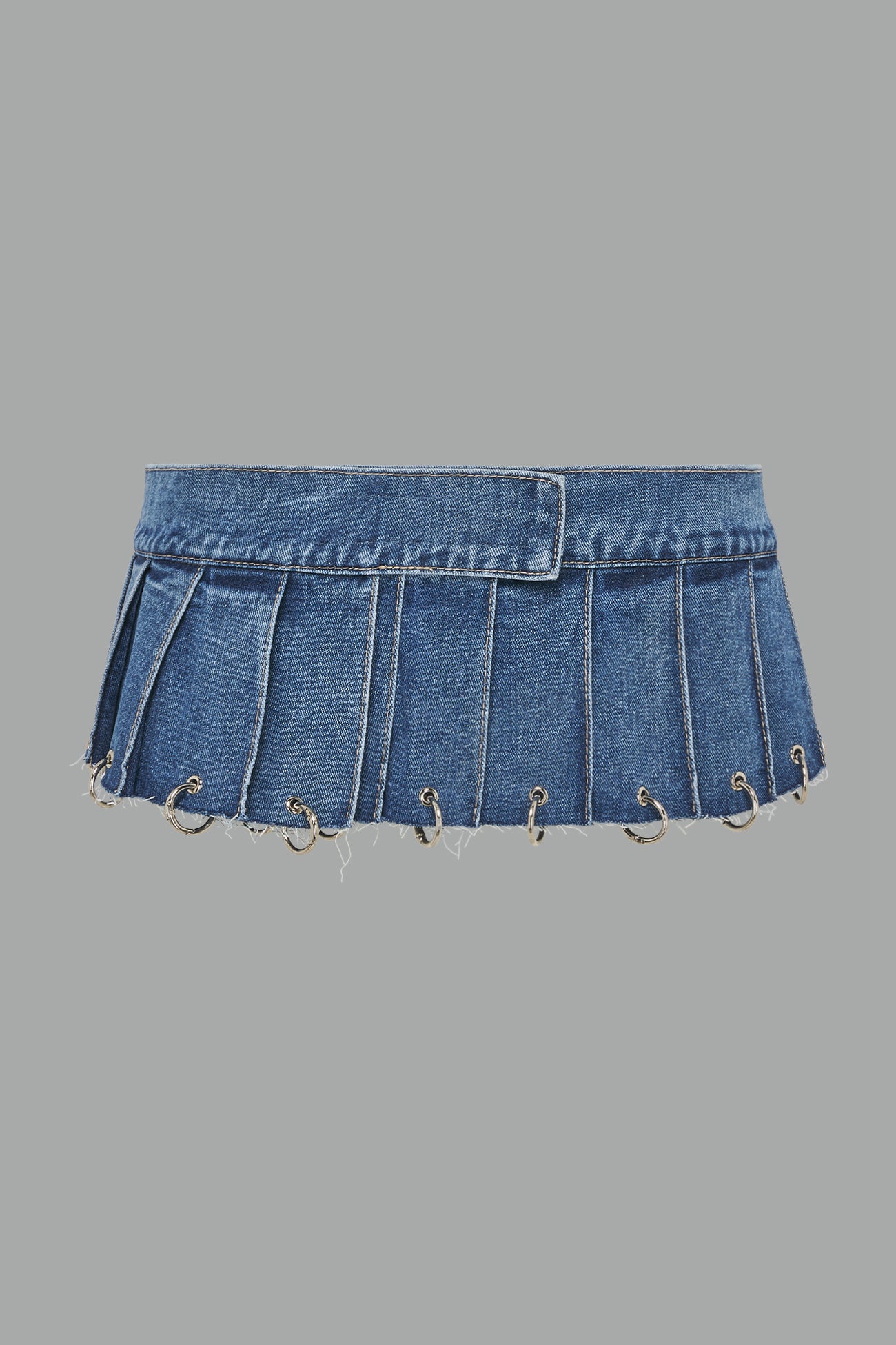 ultra-short blue washed denim pleated mini skirt featuring frayed hem, silver grommet rings, and wide belt-style front closure