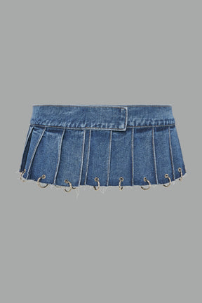 ultra-short blue washed denim pleated mini skirt featuring frayed hem, silver grommet rings, and wide belt-style front closure