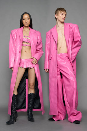 two models wearing pink croc inspired vegan leather coat with black lining