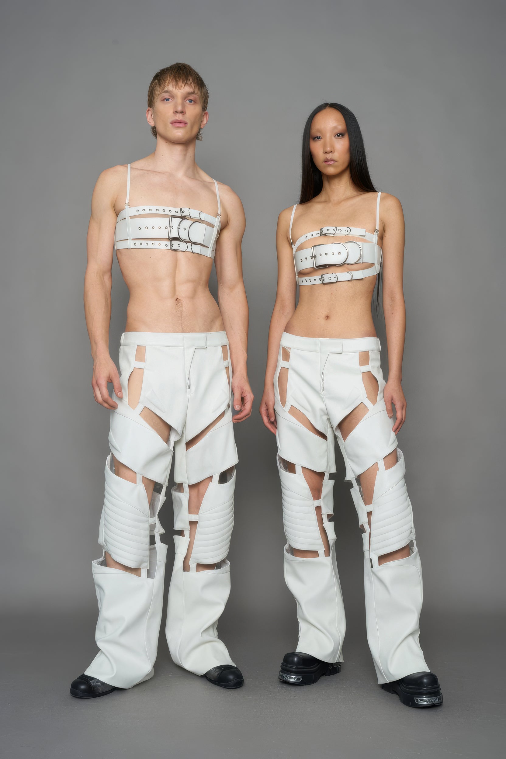 models  wearing white vegan leather pants with cut out details