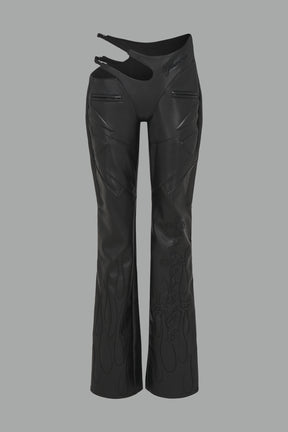 black vegan leather flare trousers with motocross paneling, padded details, flame and cross stitching, slogan embroidery, and an asymmetric waistband with adjustable elastic thong straps.