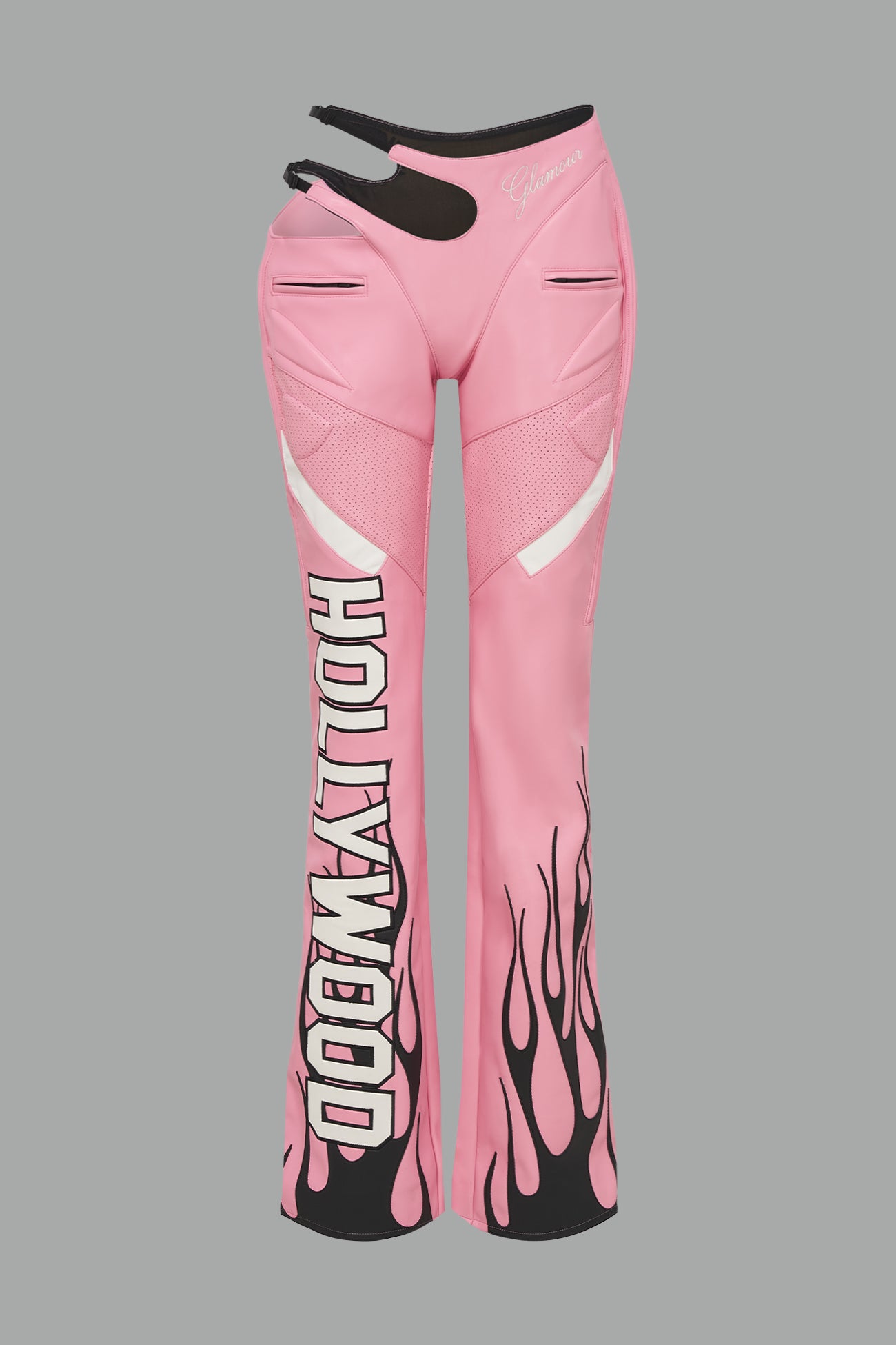 pink vegan leather flare trousers with motocross paneling, padded details, flame and cross stitching, slogan embroidery, and an asymmetric waistband with adjustable elastic thong straps.