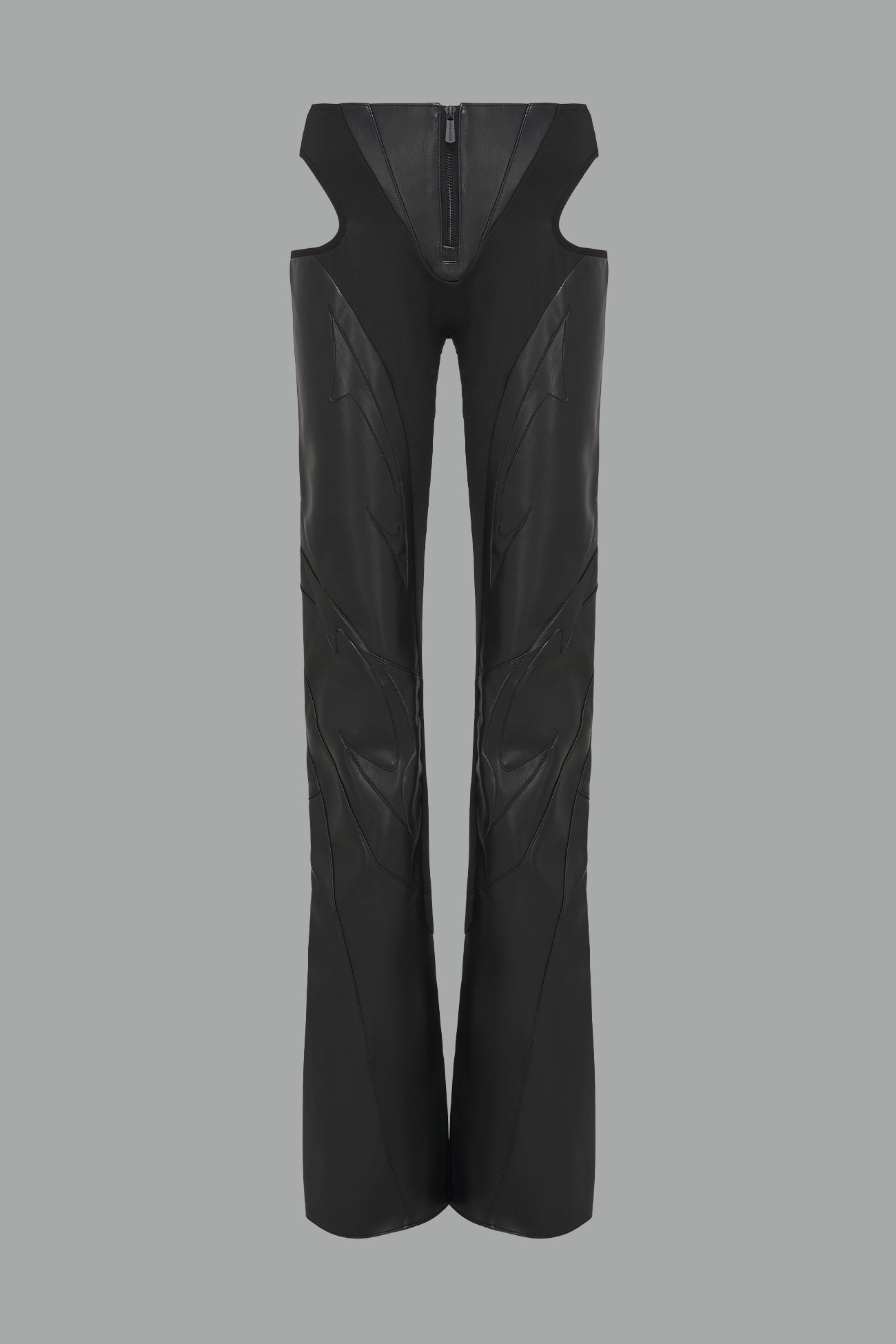 Black cut-out flare pants with graphic details, vegan leather panels, and low-rise waist – edgy motocross-inspired trousers for men’s streetwear or festival looks.