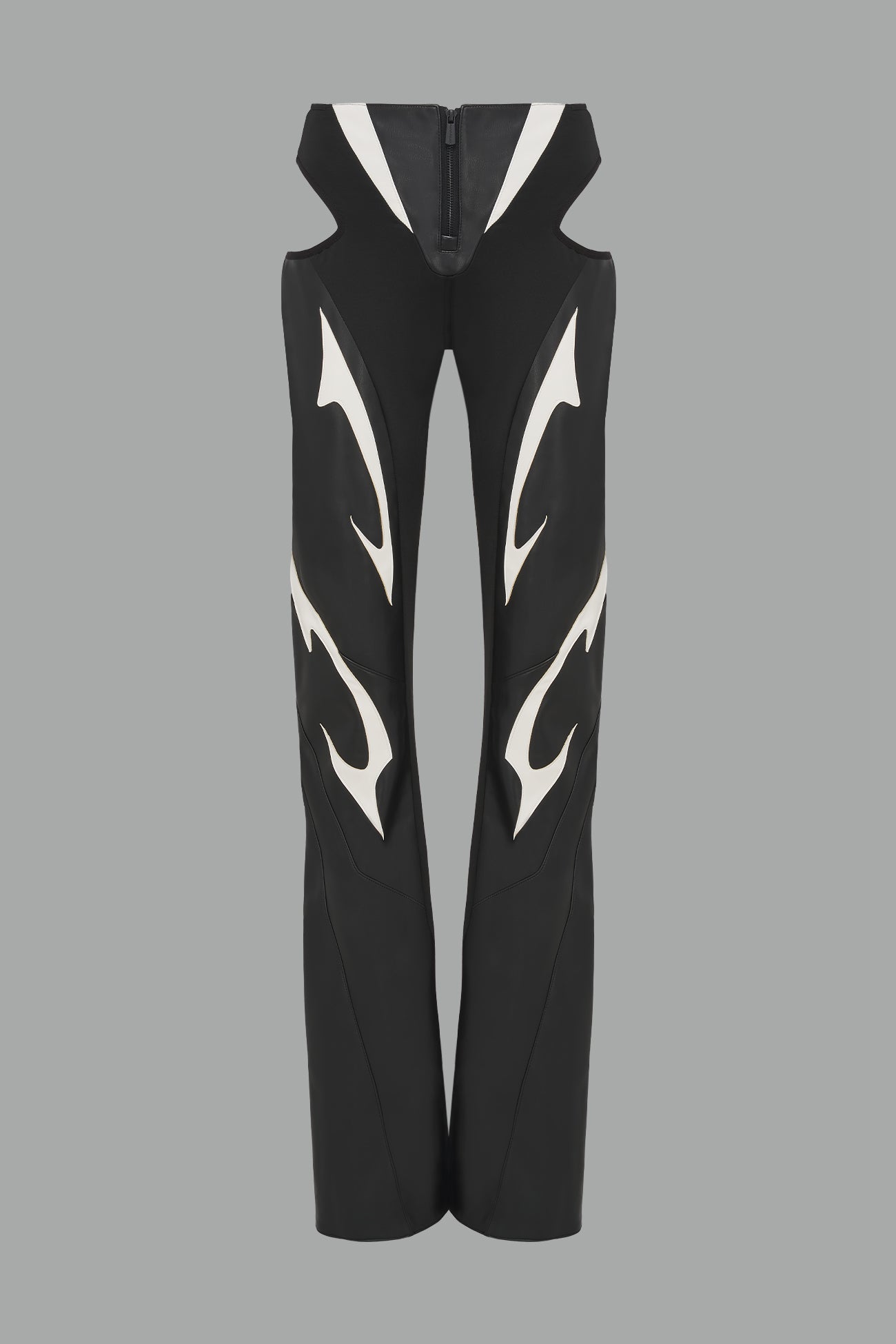 white cut-out flare pants with graphic details, vegan leather panels, and low-rise waist – edgy motocross-inspired trousers for men’s streetwear or festival looks.
