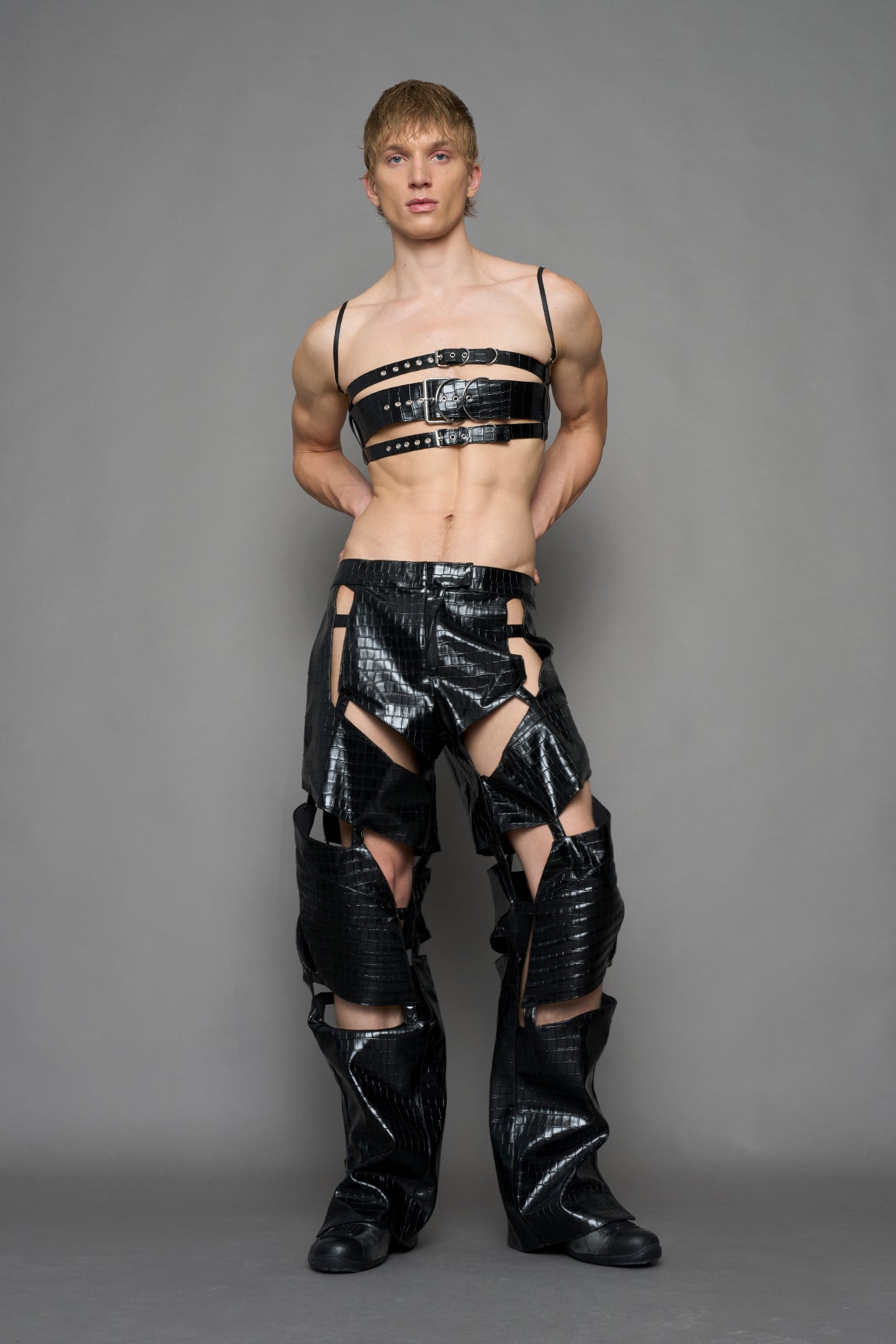 model wearing black croc vegan leather pants with cut out details