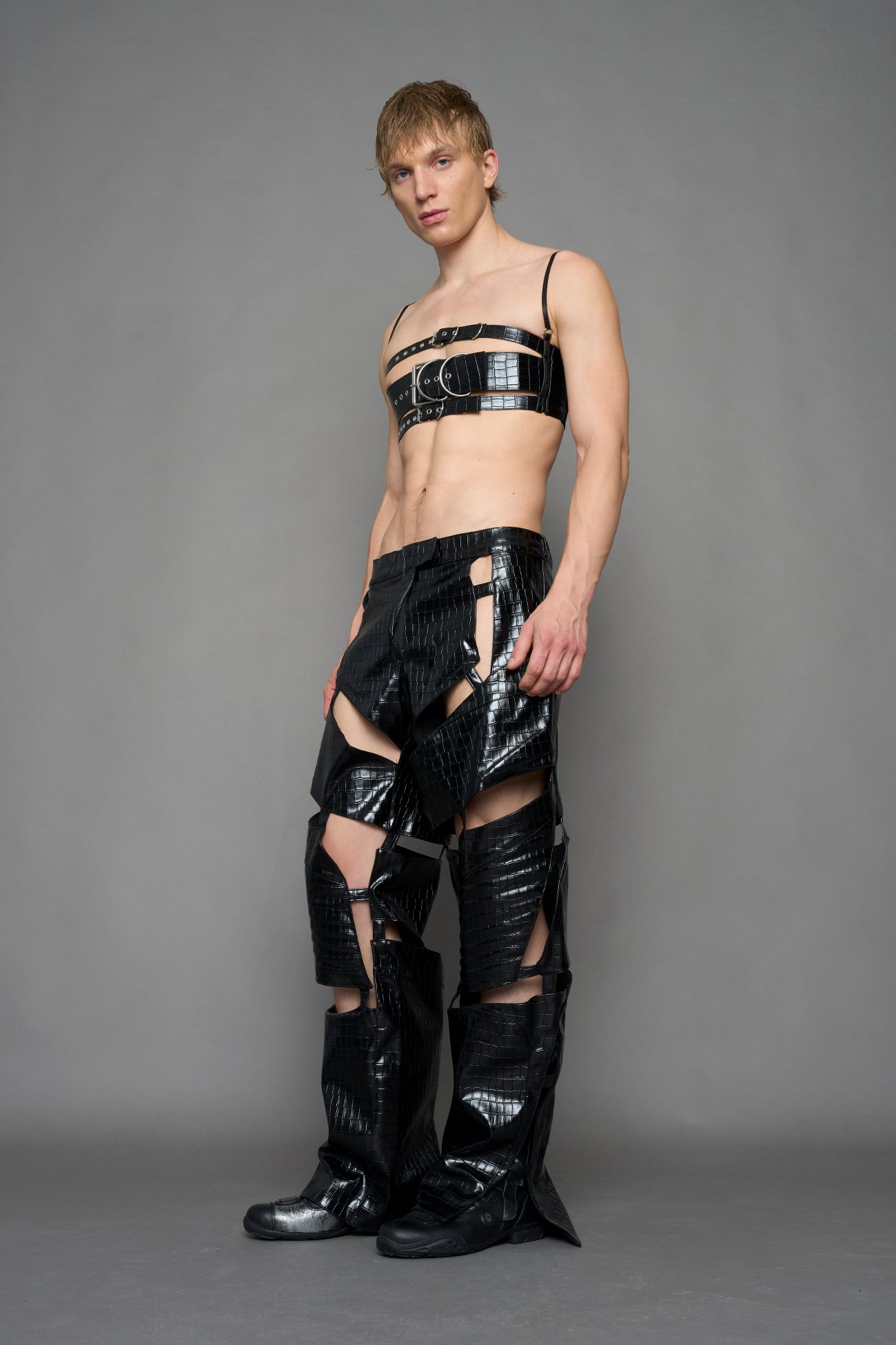 model wearing black vegan leather croc inspired belt top with buckle details