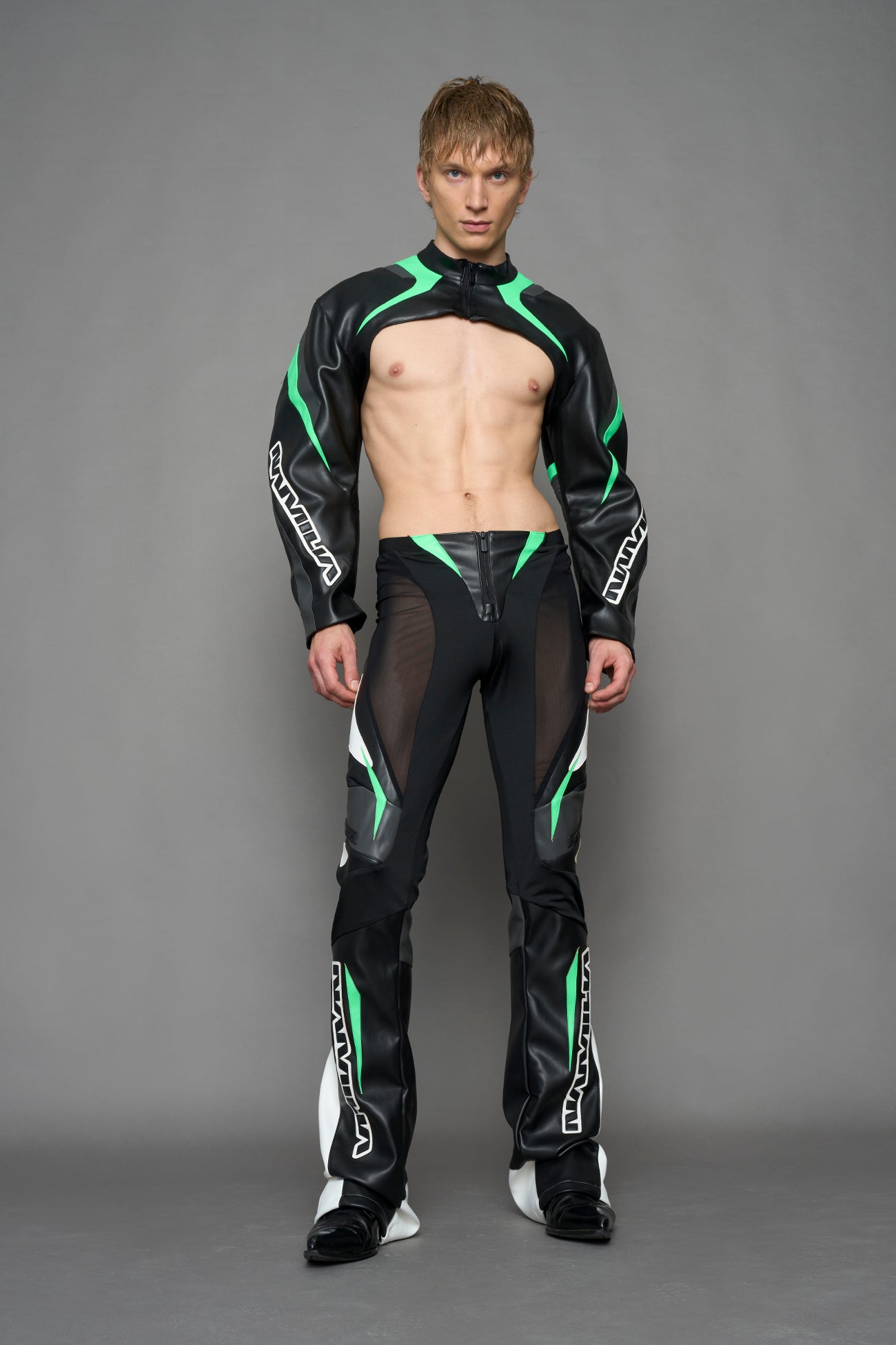 model wearing black white and green cropped jacket with logo on the arm