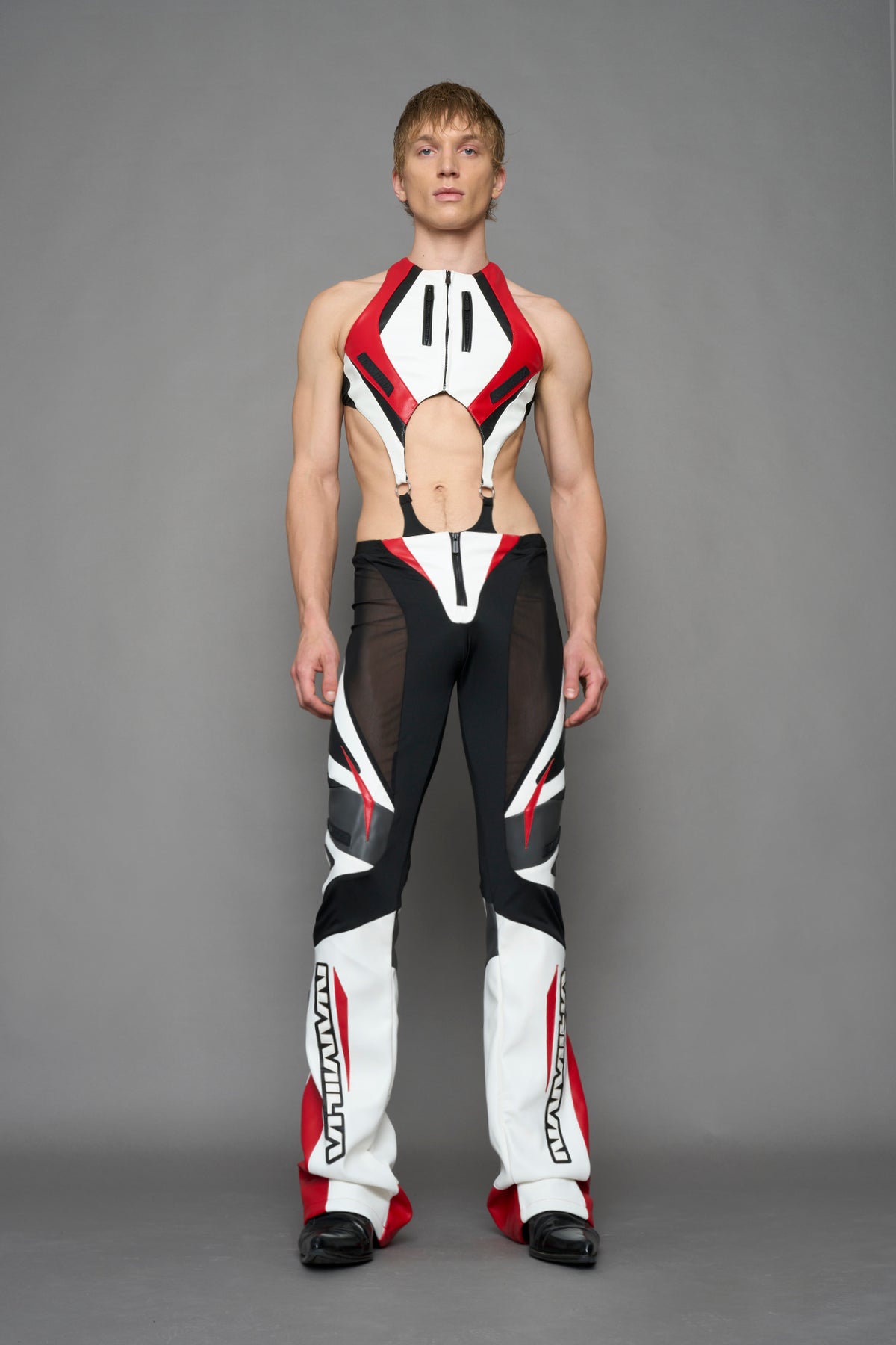 model wearing red black white moto inspired mesh pants with logo on the leg