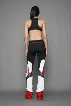 model wearing red black white moto inspired mesh pants with logo on the leg