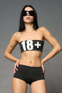 Namilia black Lycra tube top with bold “18+” print on front