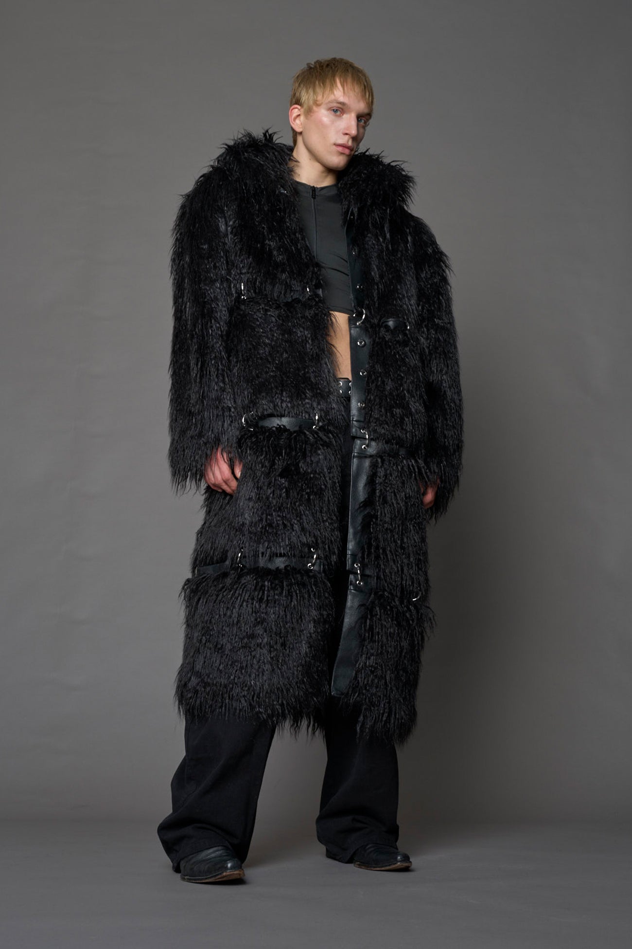 model wearing black faux fur coat with silver metal rings