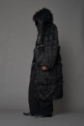 model wearing black faux fur coat with silver metal rings