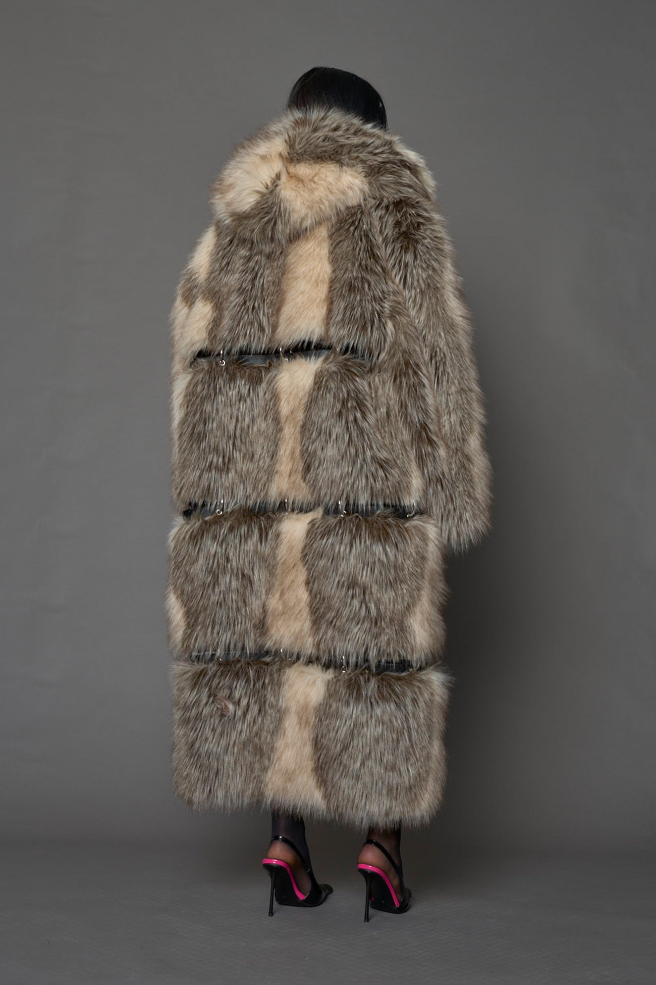 model wearing brown faux fur coat with silver metal rings