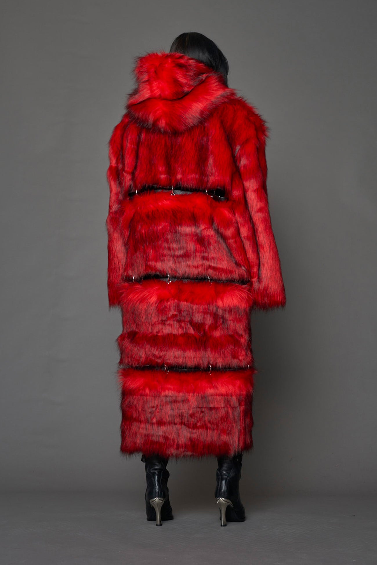 model wearing red faux fur coat with silver metal rings