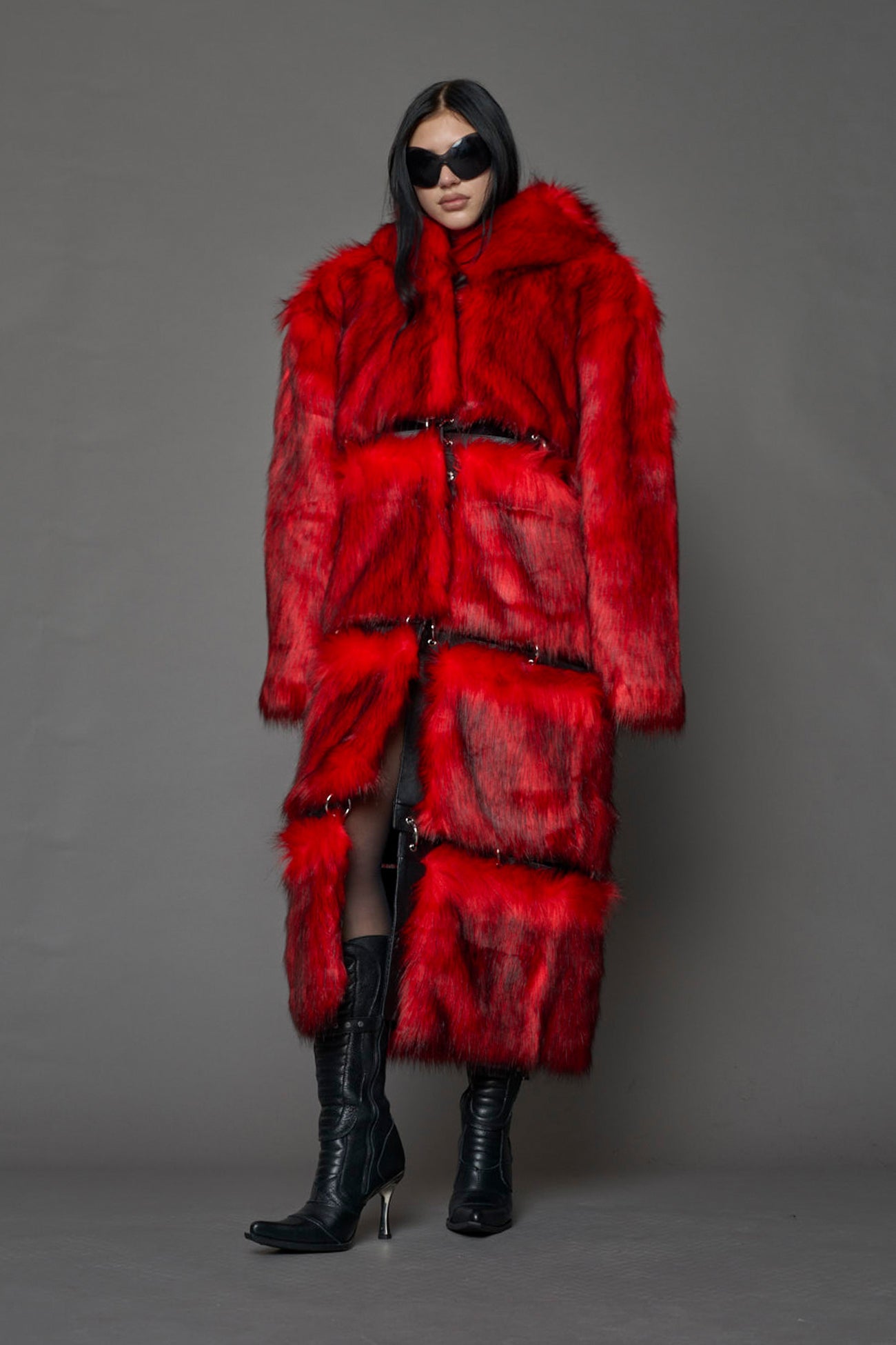 model wearing red faux fur coat with silver metal rings