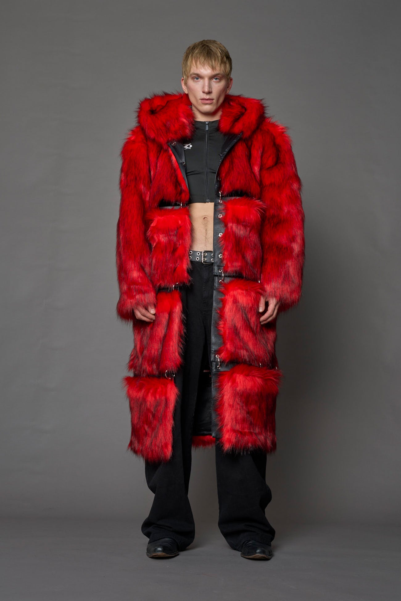 model wearing red faux fur coat with silver metal rings