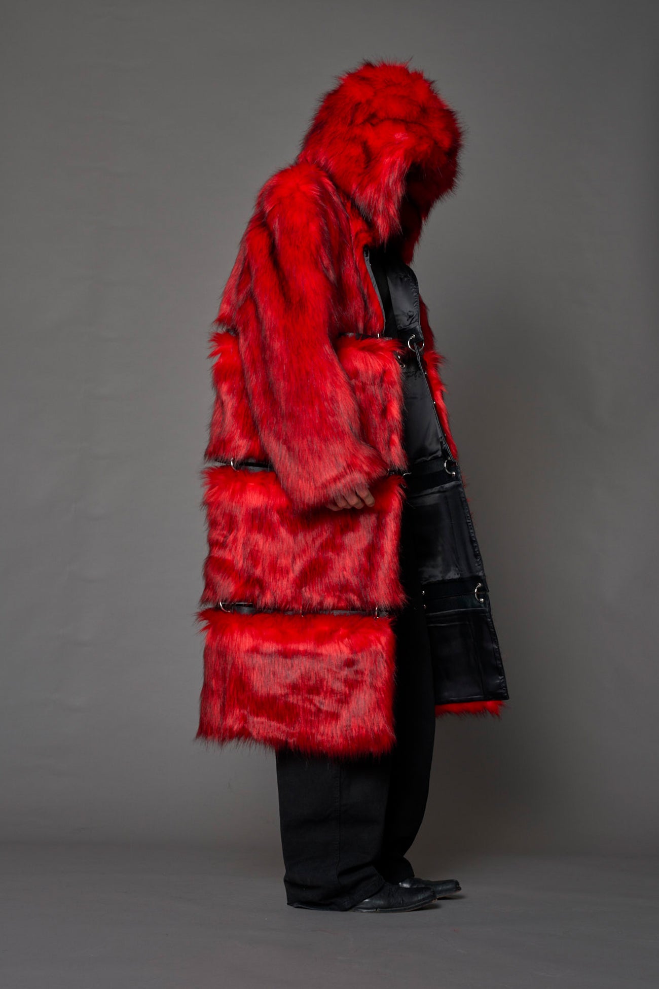model wearing red faux fur coat with silver metal rings