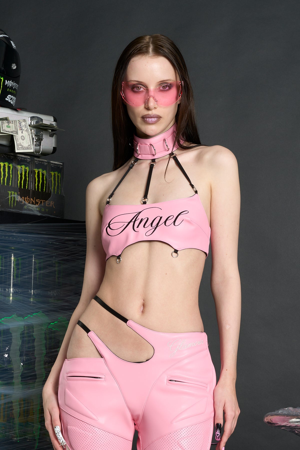 Namilia ‘Angel Choker Top’ – edgy vegan leather bandeau top with adjustable collar, cursive 'Angel' graphic, mesh panels, chrome hardware, and elastic back straps. pink version