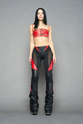 red vegan leather belt top with three adjustable grommet straps, oversized metal buckles, and circular hardware – edgy bondage-inspired crop top for festival or clubwear.
