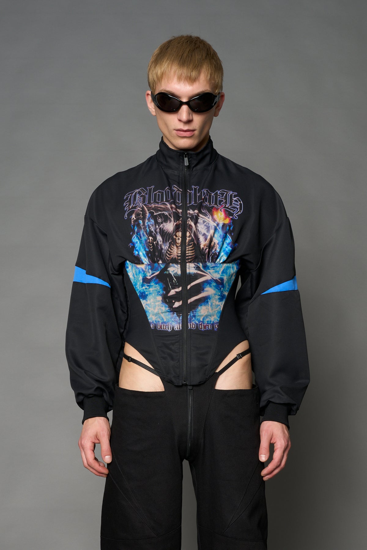 Black Namilia cropped tracksuit jacket with sleeve stripes, gothic graphic print, and lace-up corset back