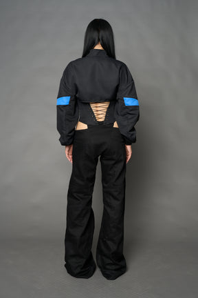 Black Namilia cropped tracksuit jacket with sleeve stripes, gothic graphic print, and lace-up corset back
