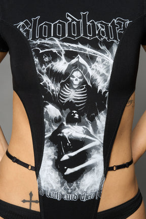 Black Namilia Bloodbath bodysuit with gothic skeleton graphic, cut-out sides, high-cut leg and strap details