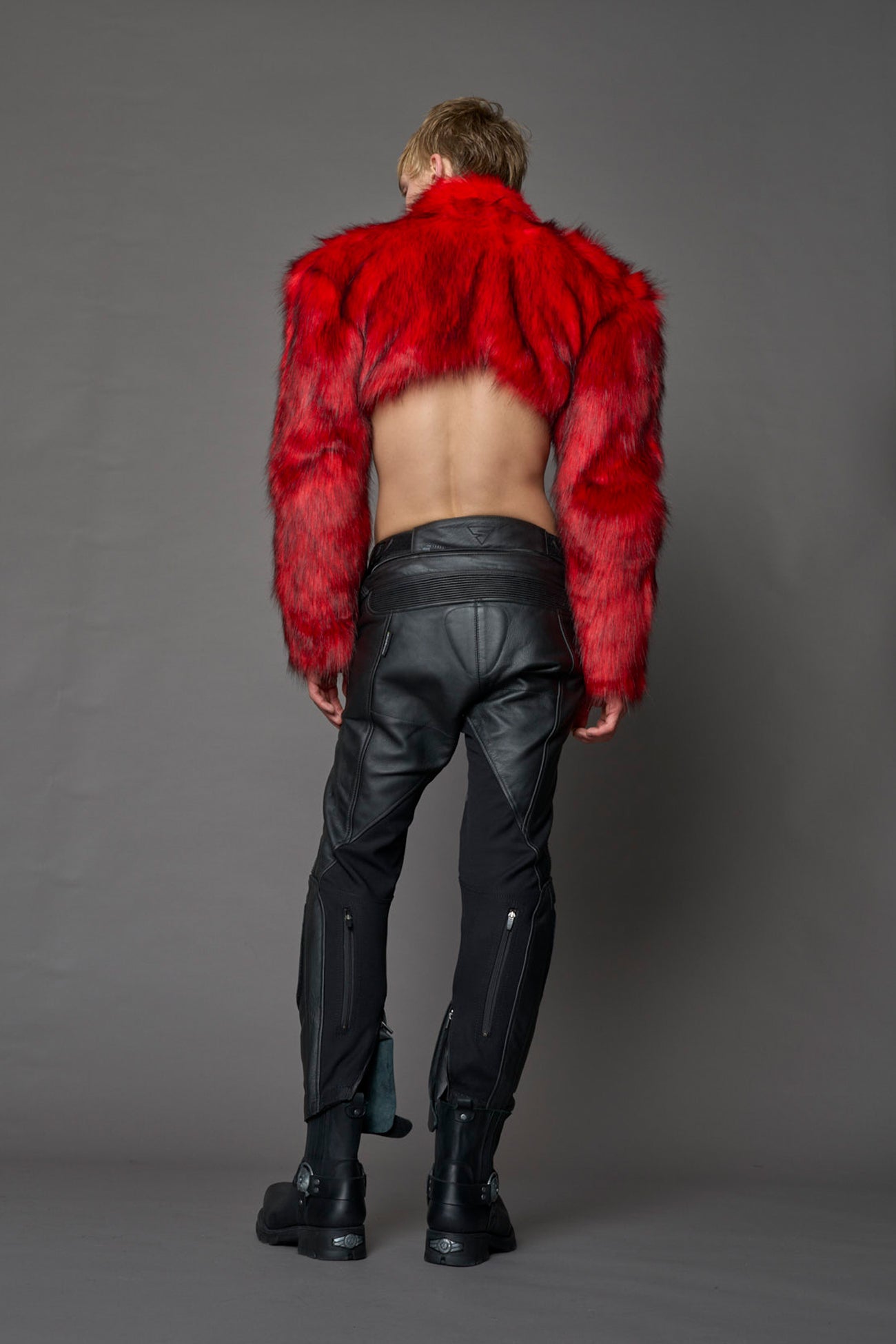 red cropped faux fur jacket with exaggerated shoulders and high neck – bold statement outerwear for nightlife, streetwear, or runway looks.