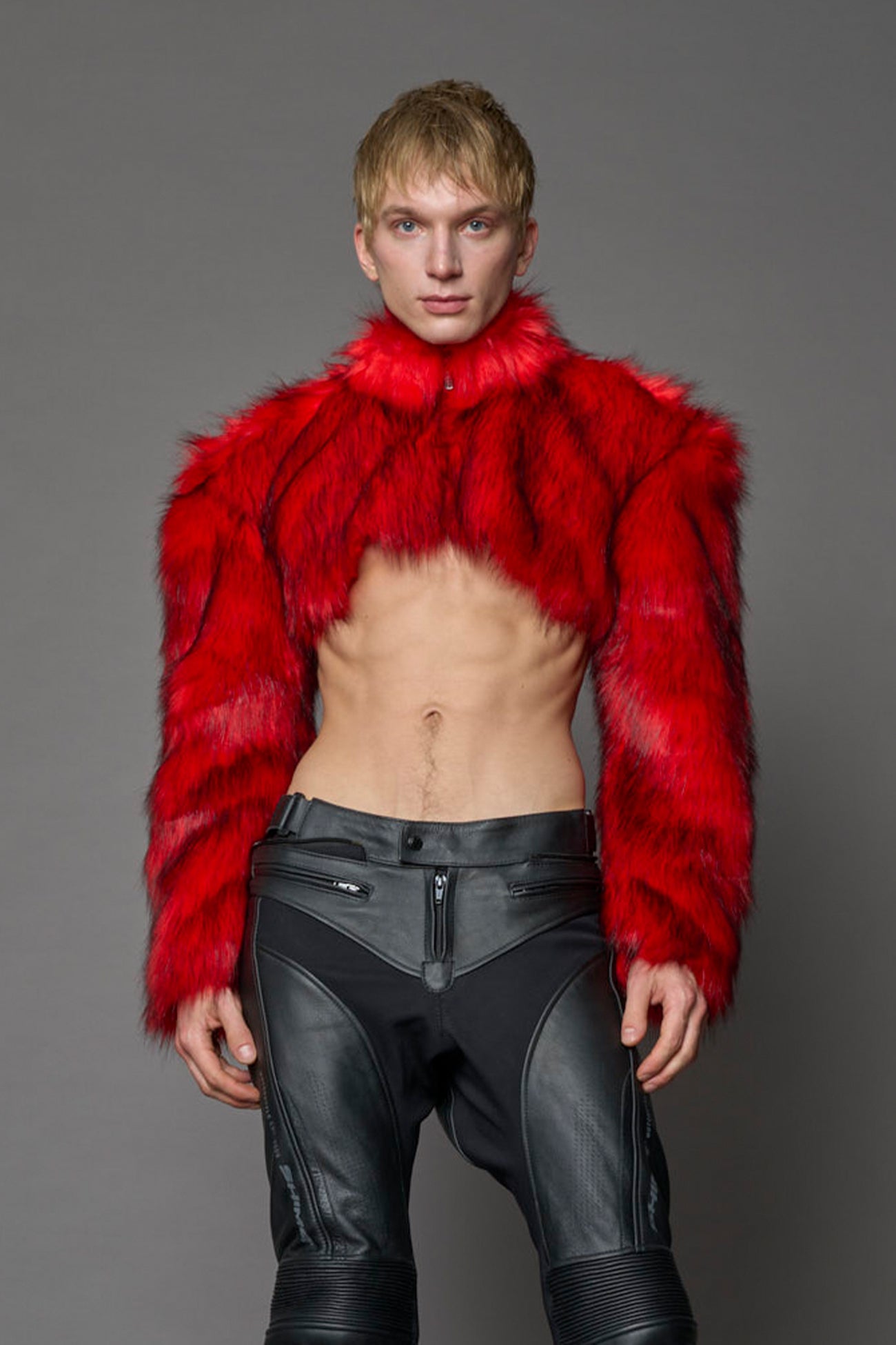 red cropped faux fur jacket with exaggerated shoulders and high neck – bold statement outerwear for nightlife, streetwear, or runway looks.