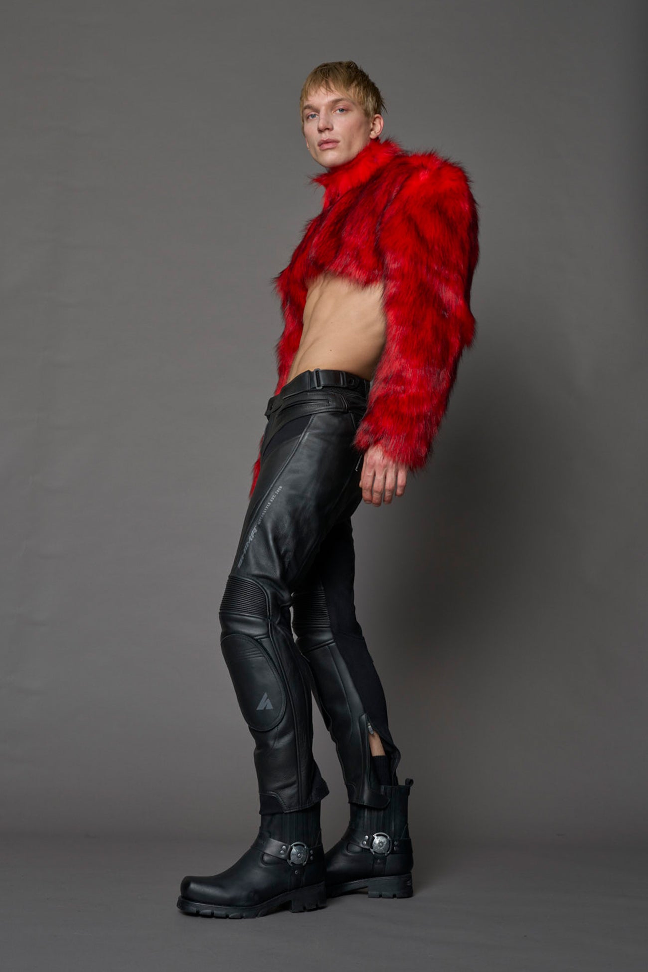 red cropped faux fur jacket with exaggerated shoulders and high neck – bold statement outerwear for nightlife, streetwear, or runway looks.