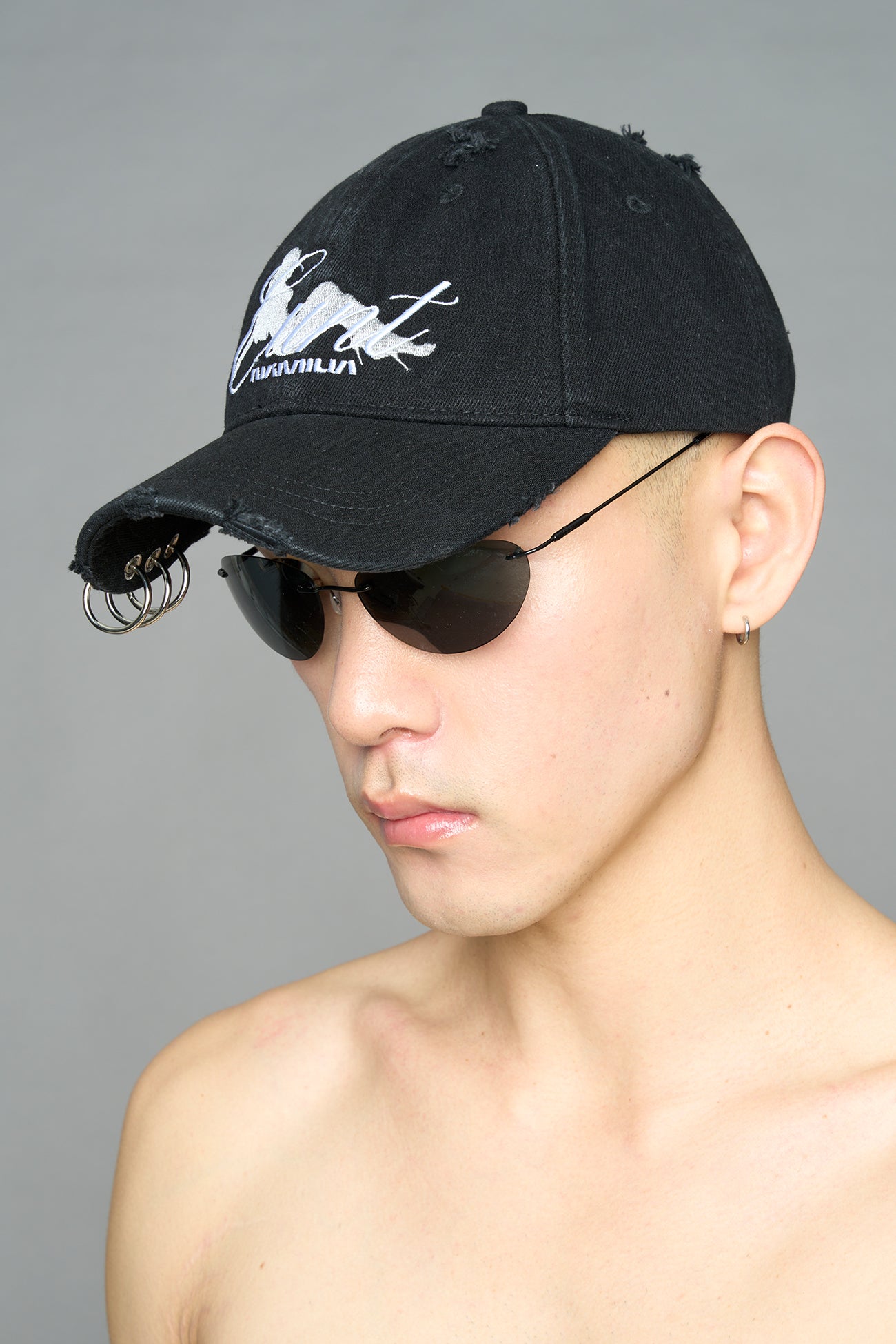 model wearing black red slogan embroidered rtrucker cap with silver ring details