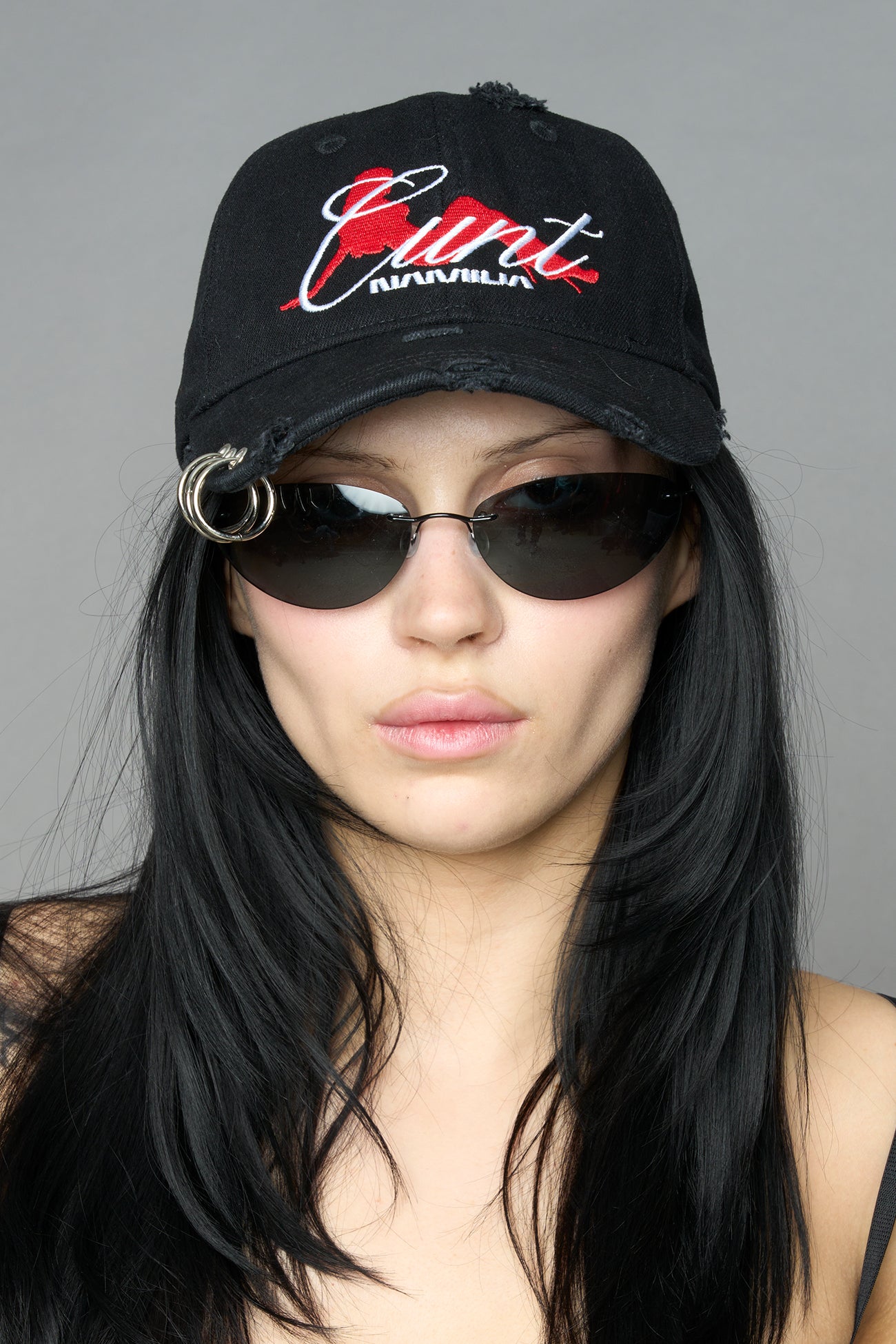 model wearing black red slogan embroidered rtrucker cap with silver ring details