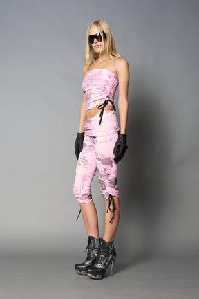 model wearing pink print soft jersey tbe top with ruching detail on the sides
