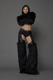 model wearing black vegan leather and faux fur chaps