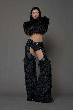 model wearing black vegan leather and faux fur chaps