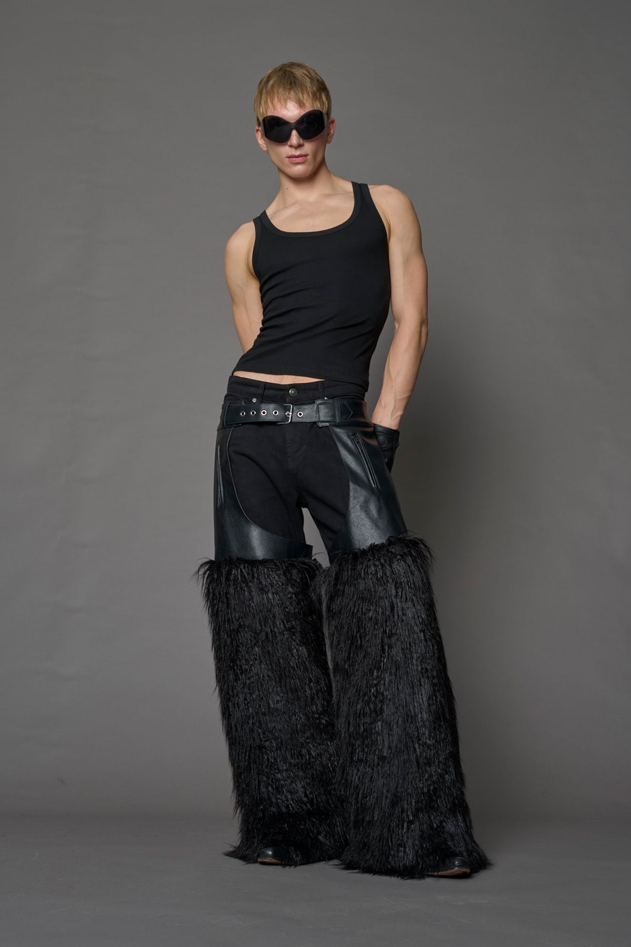 model wearing black vegan leather and faux fur chaps