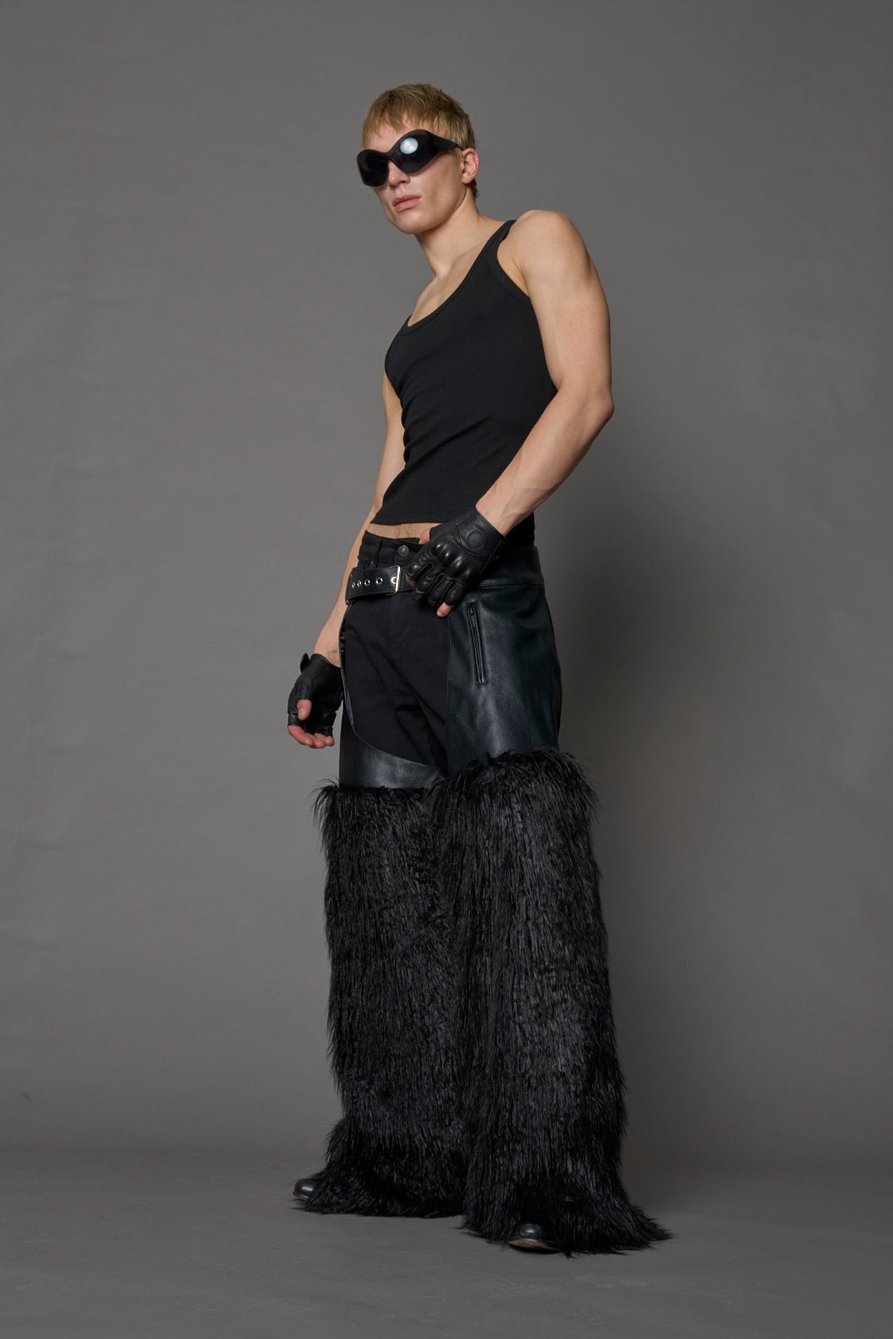 model wearing black vegan leather and faux fur chaps