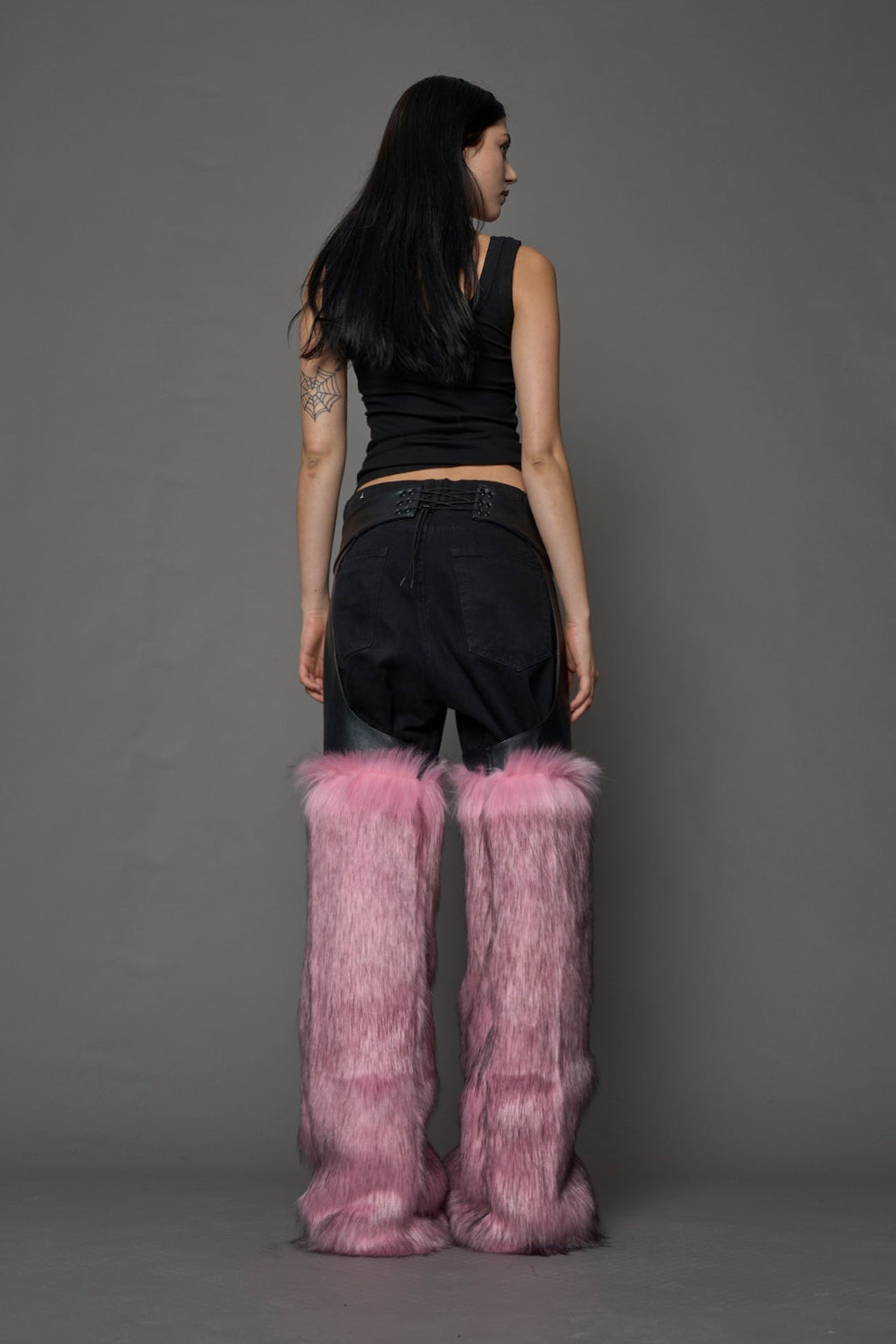 model wearing pink vegan leather and faux fur chaps