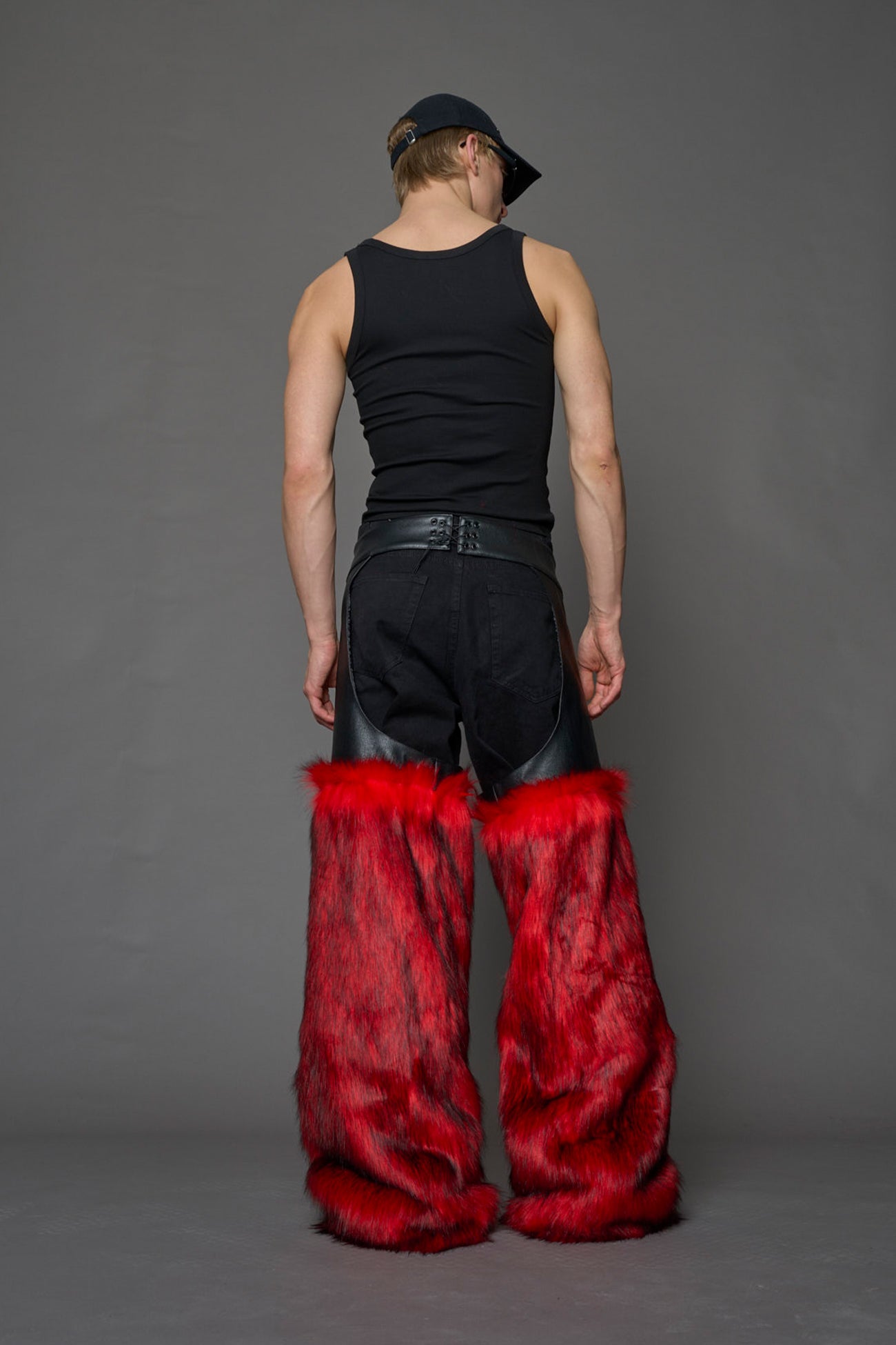 model wearing red vegan leather and faux fur chaps