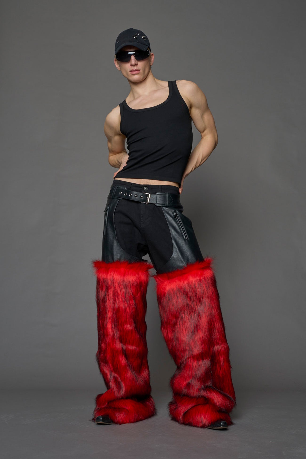 model wearing red vegan leather and faux fur chaps