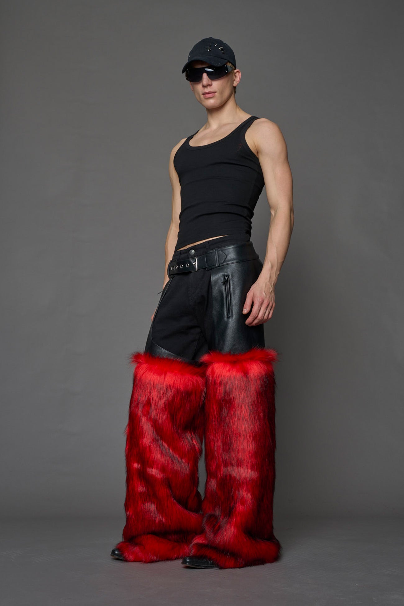 model wearing red vegan leather and faux fur chaps