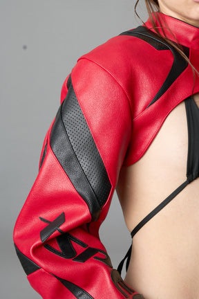 Model wearing a red vegan leather cropped jacket with a high choker collar and zipper front