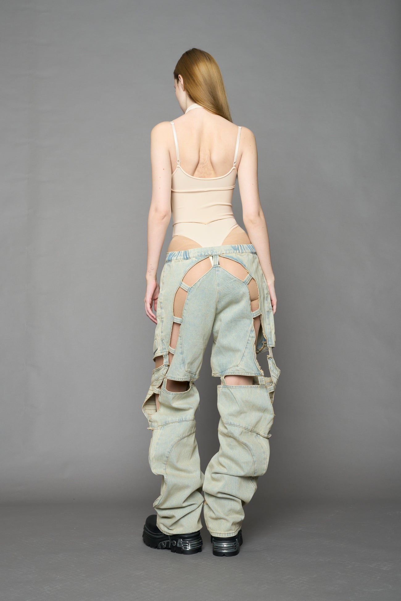 beige contour body by NAMILIA featuring a sculpted fit, corset-style waist with hook-and-eye closure, and high neckline. Statement bodywear.